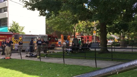 Steady static shot of firefighters in Toronto, relaxing and wrapping up Video stock 98712606