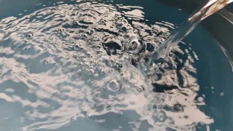 A steady stream of water flows into the blue basin Stock Footage 304055821