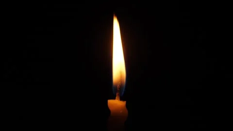 Steady Votive Flame Against Deep Black, Tall Luminous Wick Produces Calm Glow Stock Footage 324683678