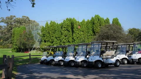 The steady wide view of Golf carts parked in the designated area at the golf Stock-Footage 302778282