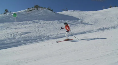 Steadycam accompanying skiing woman part II Stock Footage