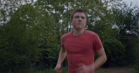 Steadycam shot, half close-up of boy running in the countryside. Stock Footage 131868099