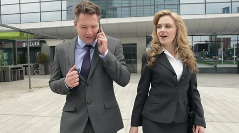 STEADYCAM Slow-Mo: Businessman Expresses Achievement While Talking On Phone. Stock-Footage 35256161
