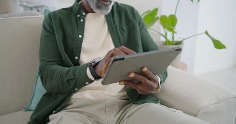 Steadying tablet with left hand, man is tapping and swiping screen to browse Stock Footage 346178605