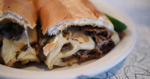 Steak and cheese sub cut in half close up ready to eat Stock Footage 213138688