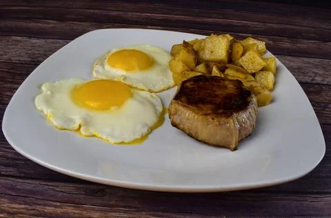 Steak and eggs Stock Photos