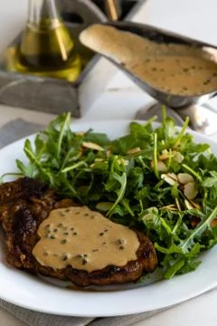 Steak with arugula Stock Photos