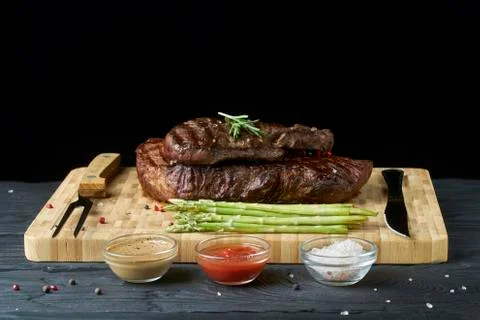 Steak with asparagus on the Board, different sauces: ketchup, barbecue sauce, Stock Photos