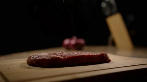 Steak being salted as camera pans around Video stock 162684844