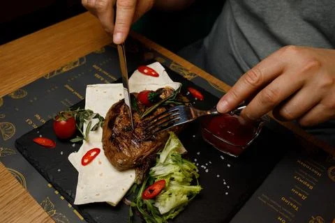 Steak on the board, restaurant meat hand Stock Photos