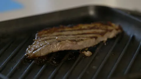 Steak comes out of pan close up Stock Footage 22041415