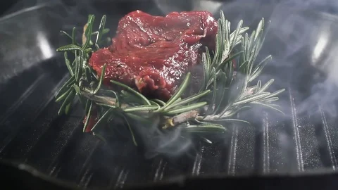 Steak is cooked in a hot grill pan, cooking in slow motion 스톡 동영상 105122062