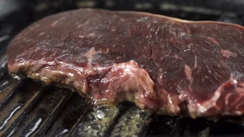 Steak is cooked in a hot grill pan, cooking in slow motion 스톡 동영상 105122064