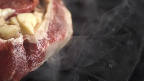 Steak is cooked in a hot grill pan, cooking in slow motion 스톡 동영상 105122090