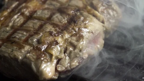 Steak is cooked in a hot grill pan, cooking in slow motion 스톡 동영상 105122105
