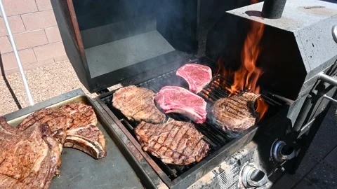 Steak cooking on a backyard Barbecue Stock Footage 135708885