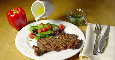 Steak Dinner And Oil Being Poured On Vegetables 08 Stock Footage 84001987