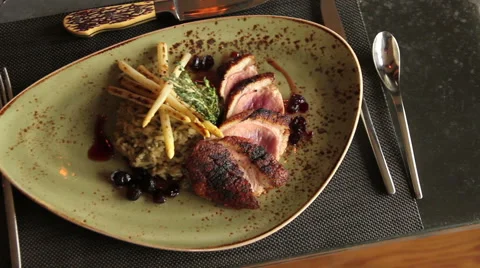 Steak dinner with rice on a fancy plate, pan left and right Stock Footage 44609204