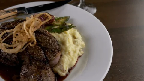 Steak dinner with sides pan left  Stock Footage 112575086