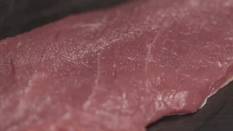 Steak filet being cooked and seasoned on a cooking plate Stock-Footage 128823279