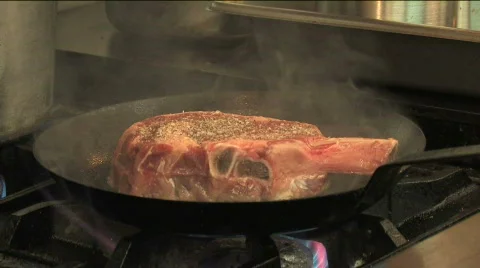 Steak Flipped in Skillet Stock Footage