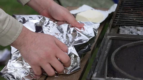 The steak in foil is placed on the grill. Stock Footage 277109559