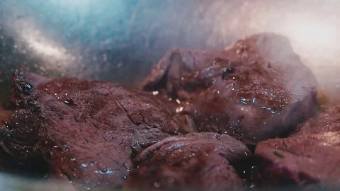Steak fried in an iron cookware Stock Footage 73211172
