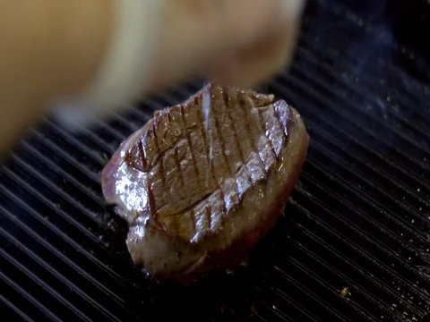 Steak fried in a skillet. slow motion Stock Footage 76056141