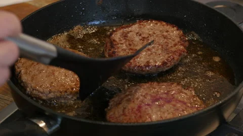Steak frying in a pan. Beef meat cooking. Food preparation theme. Stock Footage 217481885