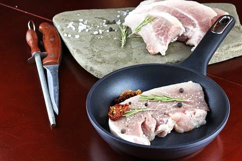 Steak in a frying pan Stock Photos