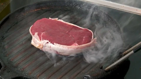 Steak on griddle Stock Footage 81638778