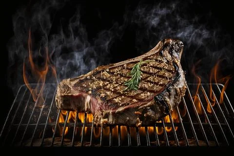 Steak on grill black background イラスト素材