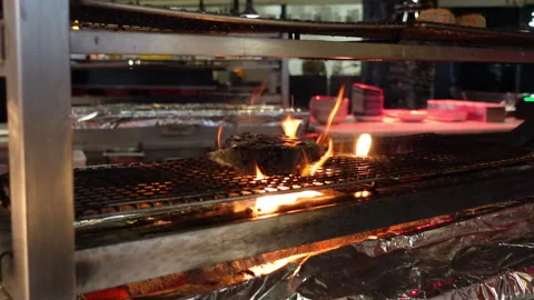 Steak grilling on flames in restaurant kitchen Stock Footage 332012558