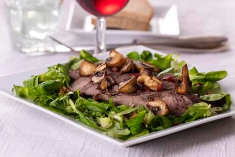 Steak on lamb's lettuce Stock Photos