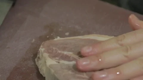 The steak lies on the table, and the chef adds seasoning Video stock 81423394
