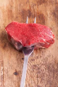 Steak on a meat fork Stock Photos