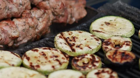 Steak meat is fried on fire and smoke. Barbecue grill with smoke on coals Stock Footage 322790773