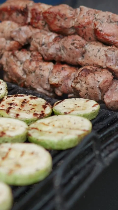 Steak meat is fried on fire and smoke. Barbecue grill with smoke on coals Stock Footage 322790829