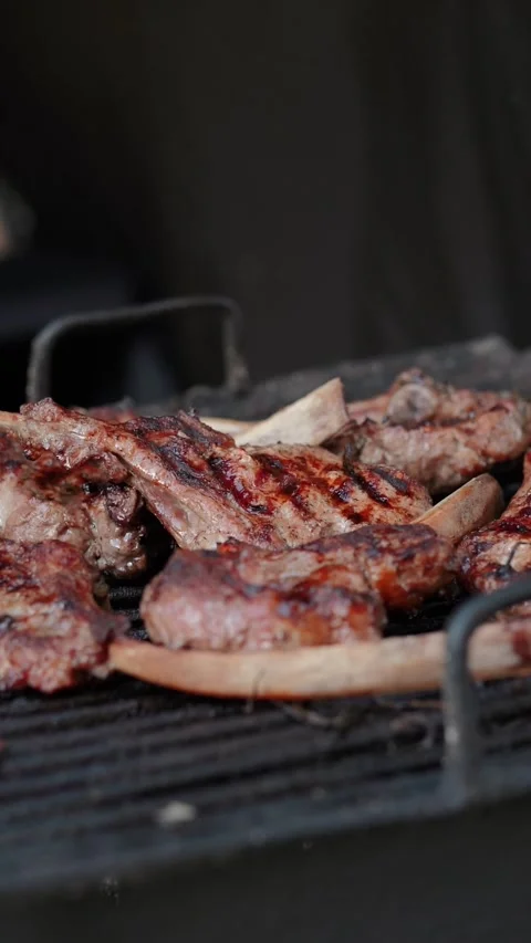 Steak meat is fried on fire and smoke. Barbecue grill with smoke on coals Stock Footage 322790849