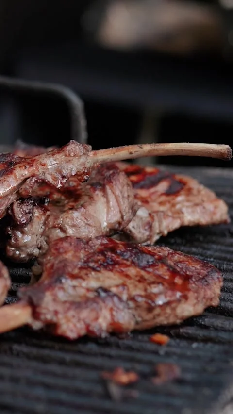 Steak meat is fried on fire and smoke. Barbecue grill with smoke on coals Stock Footage 322790936