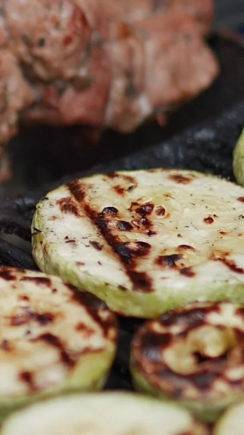 Steak meat is fried on fire and smoke. Barbecue grill with smoke on coals Stock Footage 322790948