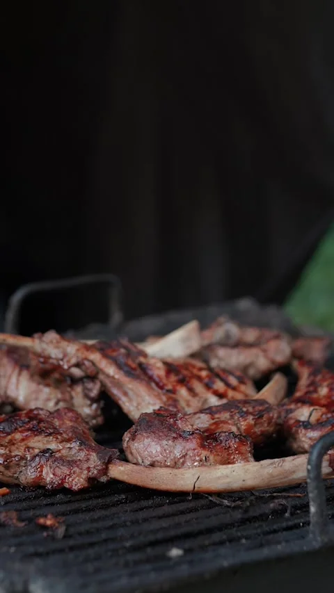Steak meat is fried on fire and smoke. Barbecue grill with smoke on coals Stock Footage 322790960