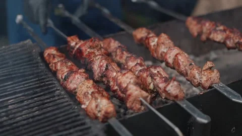Steak meat is fried on fire and smoke. Barbecue grill with smoke on coals Stock Footage 323093756
