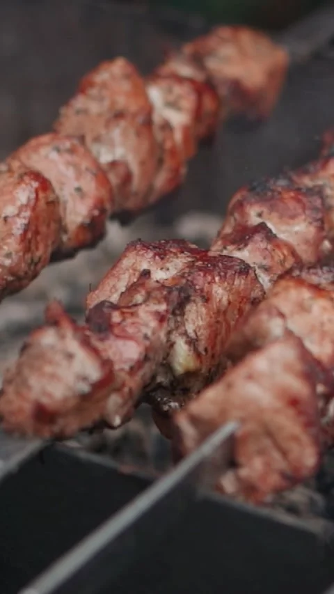 Steak meat is fried on fire and smoke. Barbecue grill with smoke on coals Stock Footage 323093880