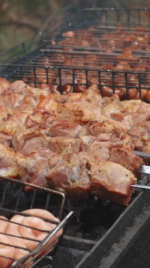 Steak meat is fried outside on fire and smoke. Barbecue grill with smoke Stock Footage 304807107