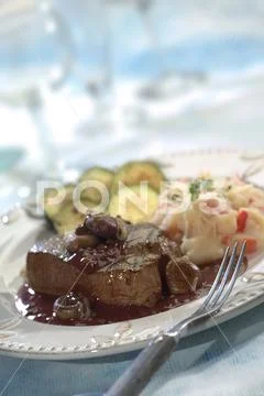 Steak with Potato Salad and Vegetables Stock Photos