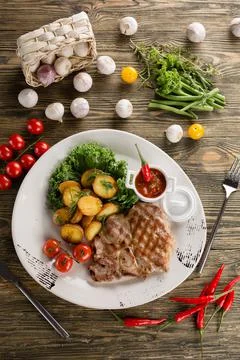 Steak with potatoes Stock Photos