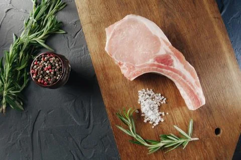 Steak raw on the table with spices view from top Photos