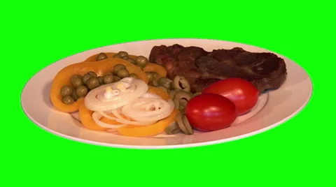 Steak with raw vegetables on plate Stock Footage 47539891