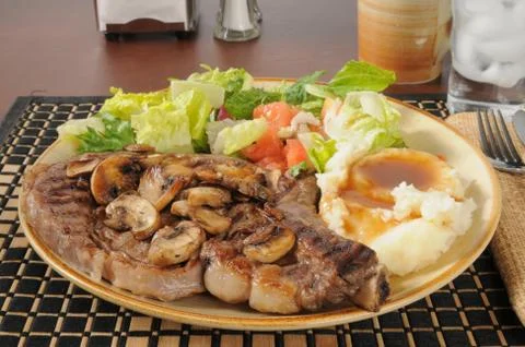 Steak with salad and mashed potatoes Stock Photos